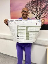 Leon holding up his ECS adults poster